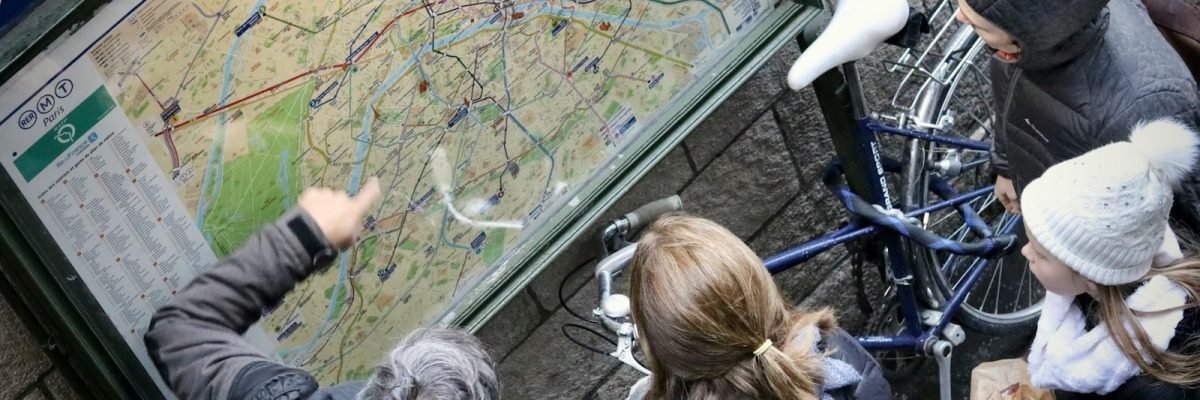 a group of people looking at a map